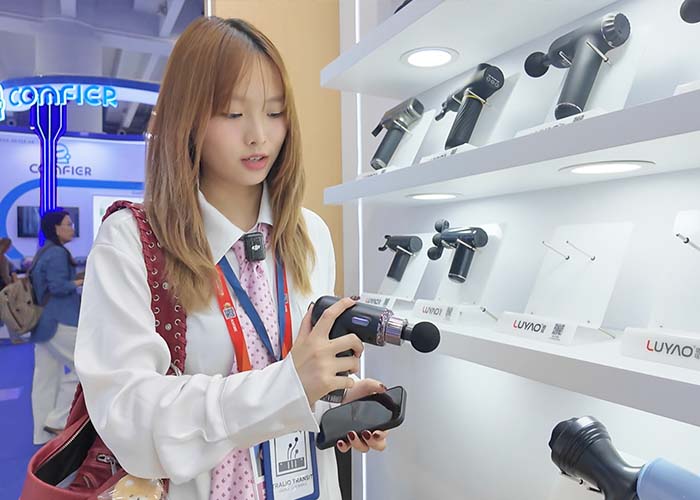 A Talio Transit employee inspects a massager supplier at an exhibition in Vietnam.